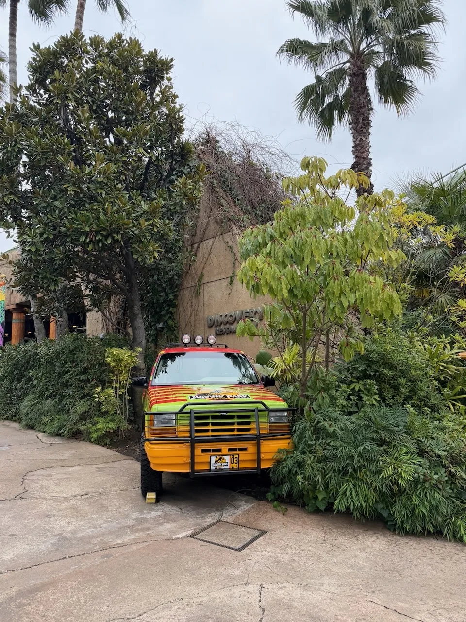 Jurassic Park jeep parked among palm trees at Universal Studios Japan