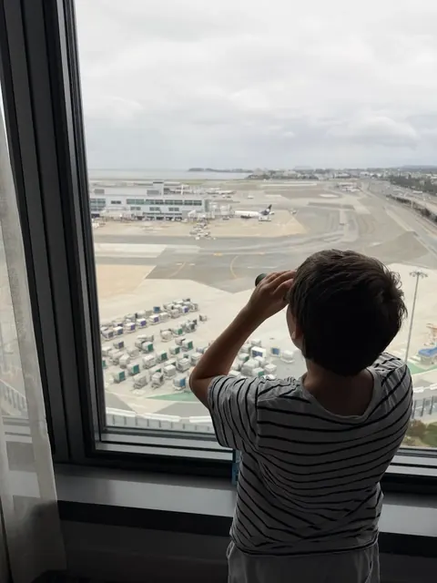 Boy watching SFO runways, from behind, San Francisco, our trip 2025 and 2026